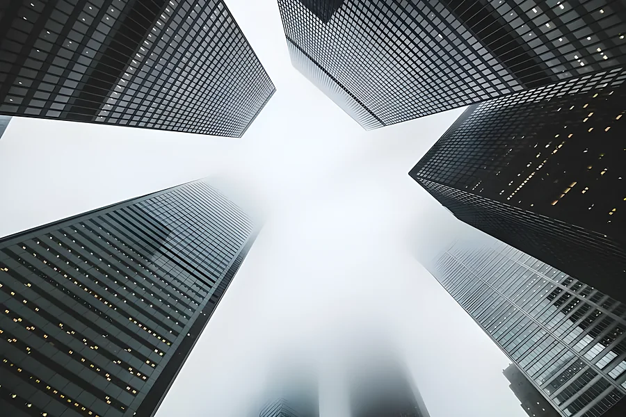 Looking straight up between glass office towers